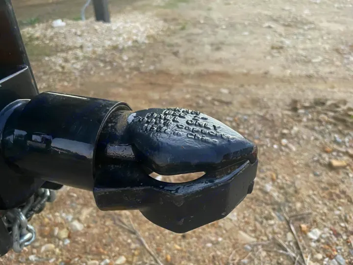 RV rental trailer hitch coupler. Black, open, with safety chains, ensuring secure towing for your next trip.. Other Other 2020