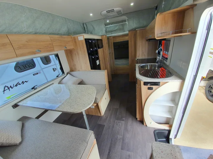 RV rental interior featuring a cozy dining nook, kitchen with sink, and a comfortable sleeping area.. Golf Maxxi 501-1 2021