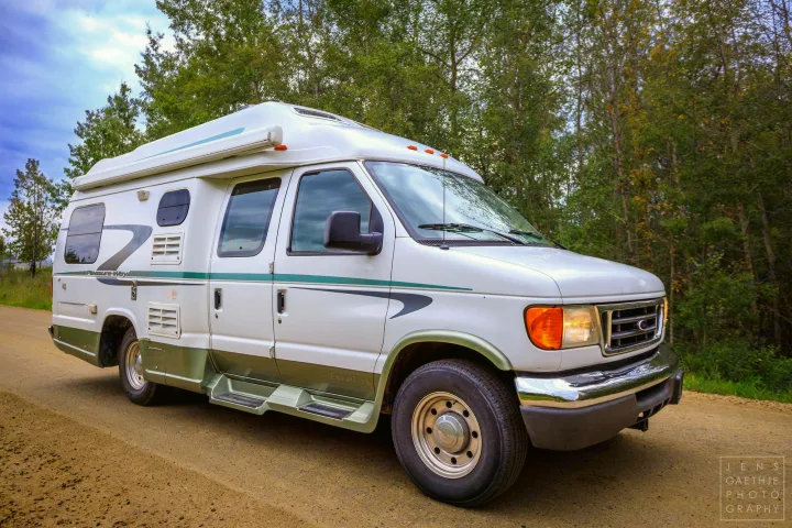 White Pleasure-Way Excel-TS RV on a dirt road, perfect for your next rv rental adventure through nature.. Ford FordE350 2006
