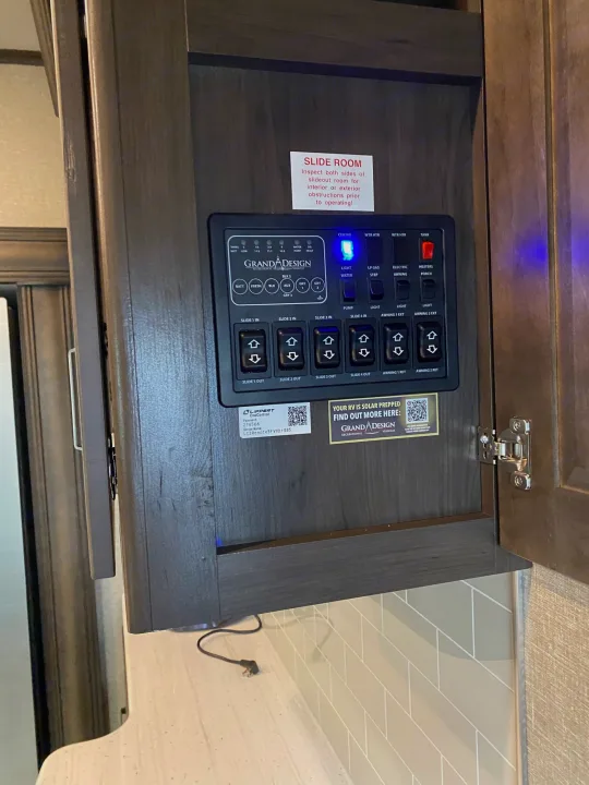 RV rental interior: Grand Design control panel with slide-out, tank levels, water heater, and lighting switches for easy operation.. Grand Design Reflection 2022