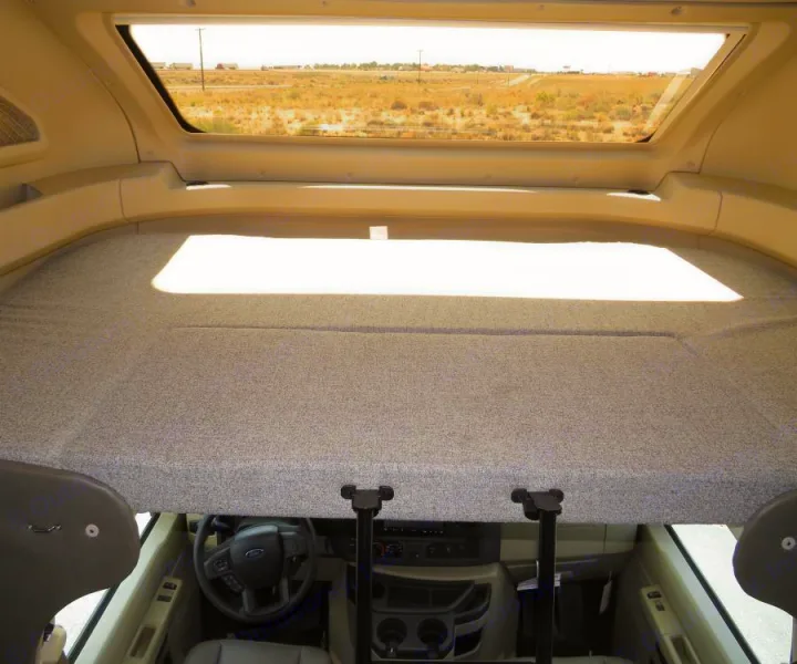 Cozy RV rental motorhome interior: cabover bed above the driver's cockpit, ready for your next adventure.. Entegra Coach Odyssey 30Z 2022