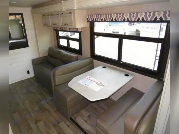 RV rental: inviting interior with dinette, sofa, overhead cabinets, and large windows.. Entegra Coach Odyssey 30Z 2022