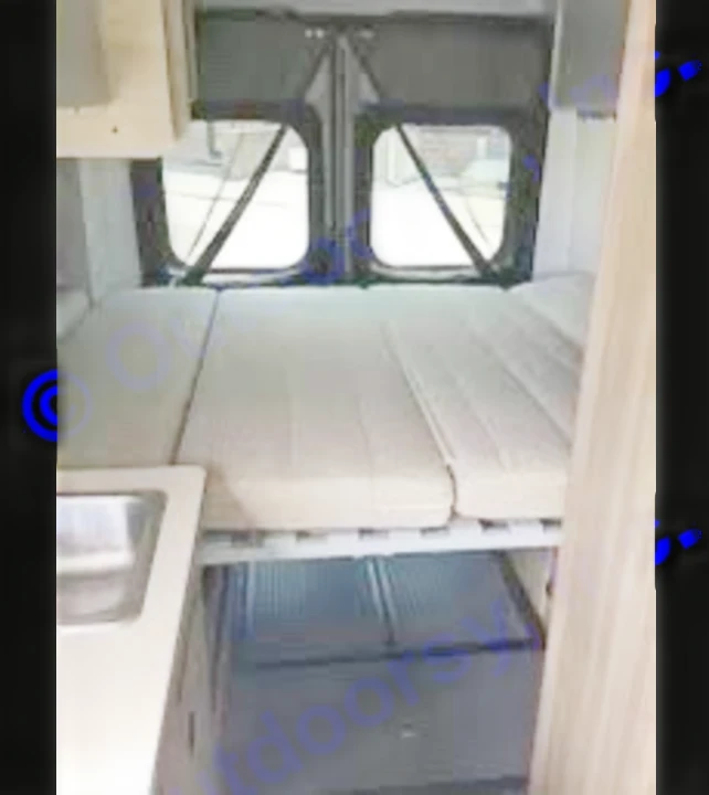 RV rental interior: A cozy camper van with a modular bed, under-bed storage, and a small kitchenette. Perfect for adventures!. Winnebago Solis 59PX 2022