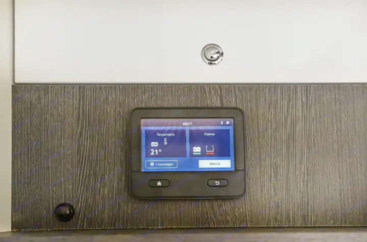 This RV rental's digital control panel displays 21°C, battery status, water levels, and one message. Essential for monitoring camper functions.. Roller Team 685 Zefiro 2022
