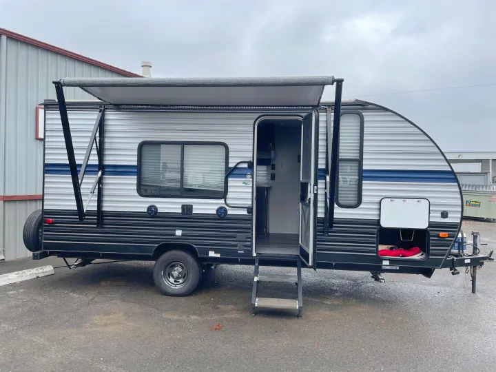 A modern travel trailer RV rental with its awning extended and door open, parked for viewing. Ready for your next adventure.. Forest River Cherokee Wolf Pup 2019