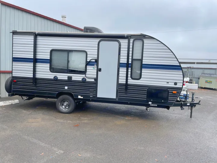 RV rental: A new travel trailer, silver with blue stripe, parked on asphalt. Perfect for camping trips!. Forest River Cherokee Wolf Pup 2019