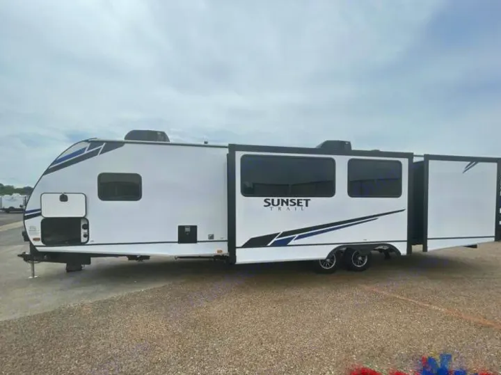 White Sunset Trail travel trailer RV rental with extended slide-outs, parked on gravel.. Crossroads Sunset Trail Super Lite 2022