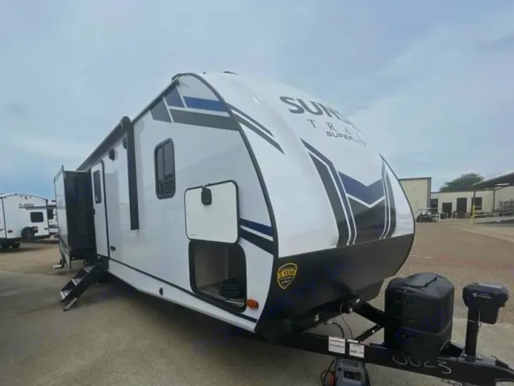 Experience outdoor adventure with this white Sun Trail travel trailer, perfect for RV rental and camping trips.. Crossroads Sunset Trail Super Lite 2022