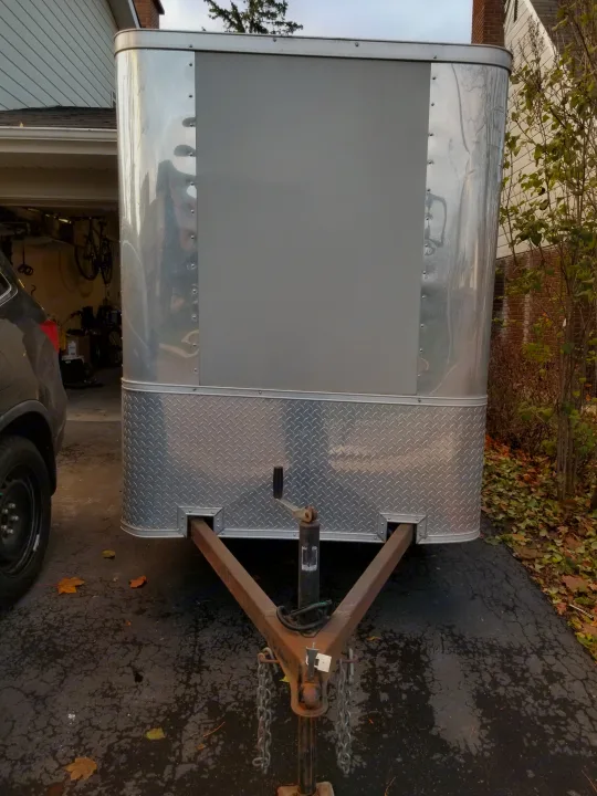 Front view of a silver enclosed utility trailer with diamond plate and hitch. Great for cargo or as an RV rental add-on.. Other Other 2012