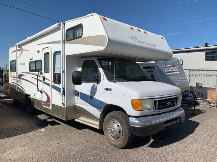 Large patio awning over entry door, lots of storage cabinets, and a large pass-thru compartment in the rear.. Coachmen Freelander Deluxe/Premier 2005