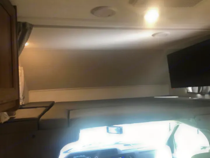 Spacious over-cab bunk bed and entertainment TV inside this RV rental. Perfect sleeping area for travel adventures.. Forest River Other 2021