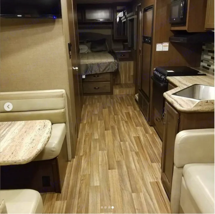 Spacious RV rental interior featuring a full kitchen, dinette, and rear bedroom. Perfect for travel adventures.. Thor A.C.E. 2018