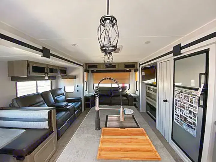 Spacious RV rental interior featuring a modern kitchen, comfortable living area, and dinette.. Palomino Puma 31-RLQS 2022