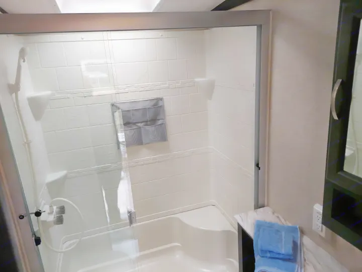 RV rental: Clean, modern bathroom with shower/tub, glass doors, and convenient hanging storage.. Coachmen Other 2020