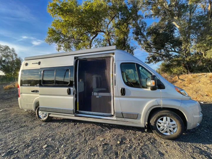 Screen door shown to keep the bugs out and provide some privacy.. Winnebago Travato 2018