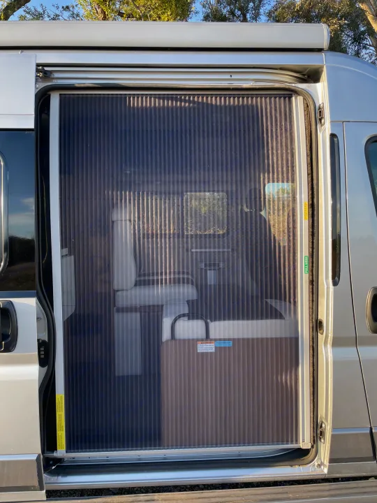 Screen door shown to keep the bugs out and provide some privacy.. Winnebago Travato 2018