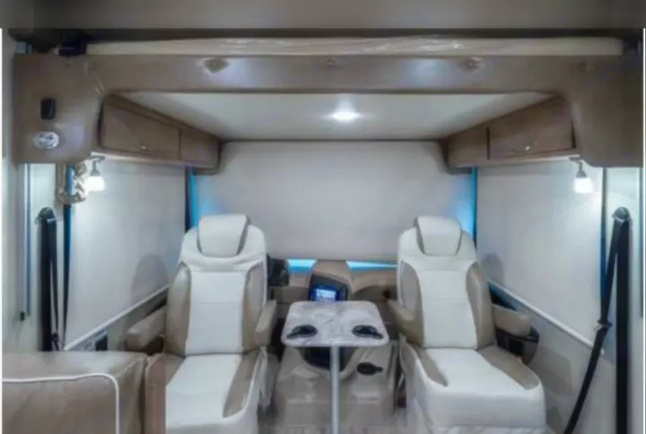 Captain chairs that swivel with cocktail table . Entegra Coach Vision 2019