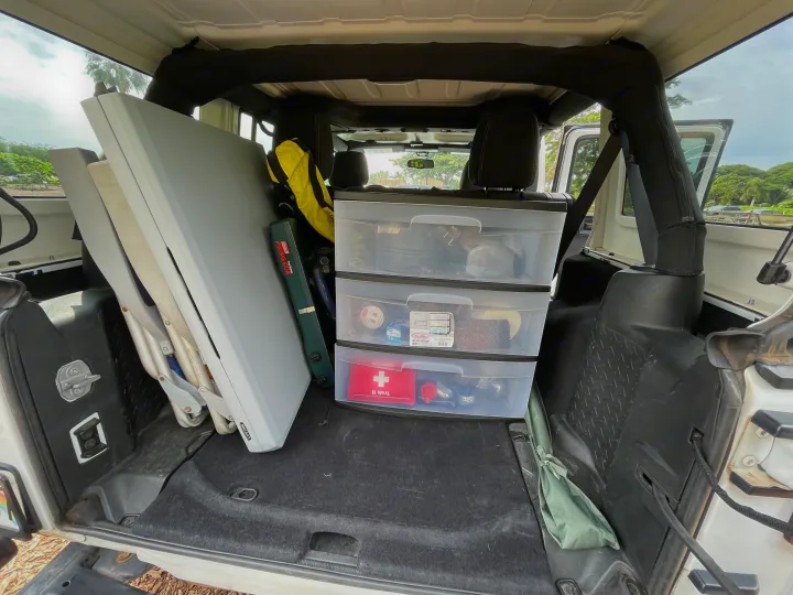 Back of a Jeep filled with camping essentials: stove, tables, & organized storage. Great for an RV rental alternative.. Jeep Wrangler 2017