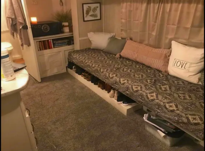 This RV rental offers practical small space solutions: a cozy daybed, under-bed shoe storage, and built-in shelving.. Heartland North Trail 2009