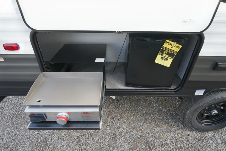 An RV rental's outdoor kitchen features a pull-out Suburban griddle and Ever Chill mini-fridge for cooking convenience.. Wildwood FSX 178BHsk 2022