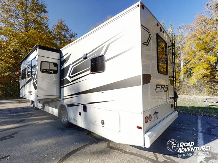White Forest River FR3 RV rental, extended for a fall trip. Parked among golden trees under a blue sky.. Forest River Fr3 2021