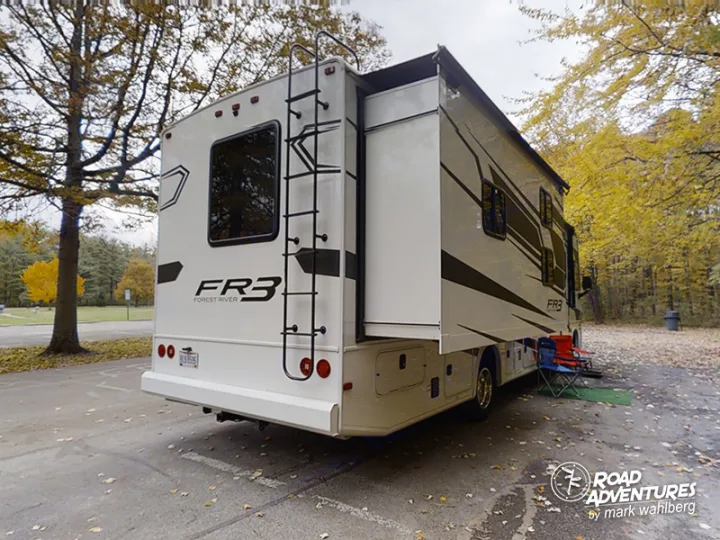 Explore autumn beauty in an RV rental! This FR3 motorhome is parked, slide-out extended, surrounded by fall foliage.. Forest River Fr3 2021