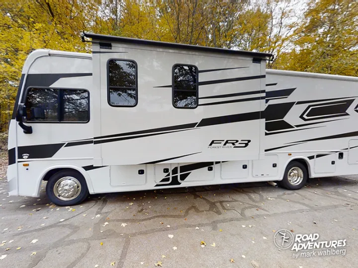 A large white Forest River FR3 RV with black graphics and an extended slide-out. Ideal for your next RV rental adventure.. Forest River Fr3 2021