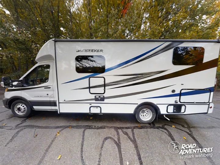 White Sunseeker motorhome with graphic details, parked outdoors. Perfect RV rental for your next road adventure.. Forest River Sunseeker 2022