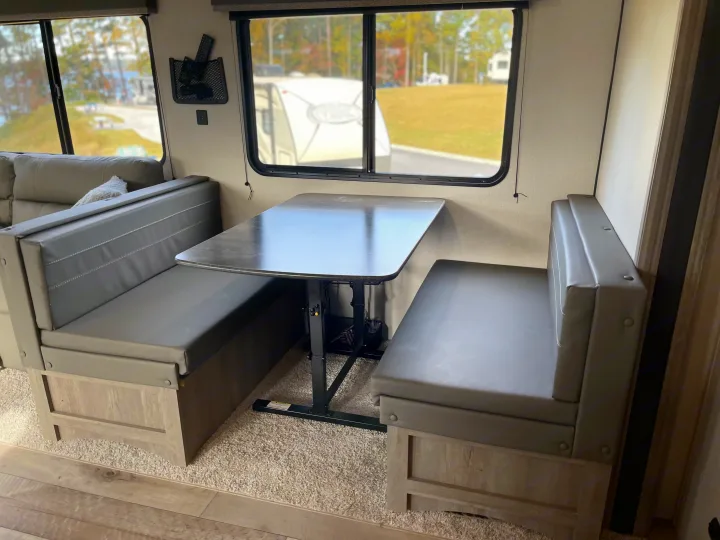 This inviting RV rental dinette offers comfortable seating and a scenic window view, ideal for your next trip.. Keystone RV Springdale 2021