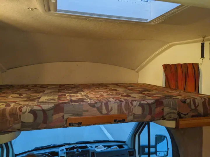 This RV rental features a comfortable cab-over bunk bed with a skylight and privacy curtain, ideal for travelers.. Winnebago Itasca Navion 2008