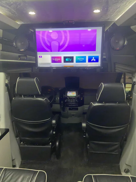 Inside a premium rv rental: Enjoy a large Apple TV entertainment system, luxury seating, and high-fidelity audio.. Mercedes-Benz MB140 2015