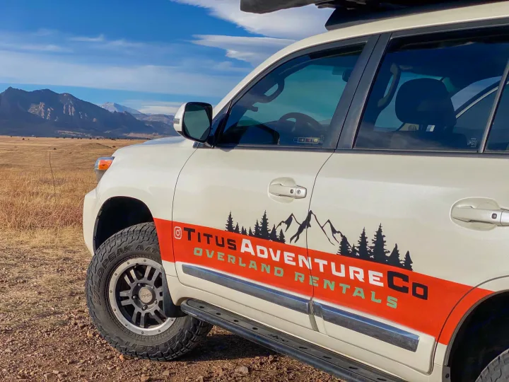Titus Adventure Co. overland RV rental SUV parked amidst mountains, ready for off-road adventure.. Toyota Land Cruiser 2016