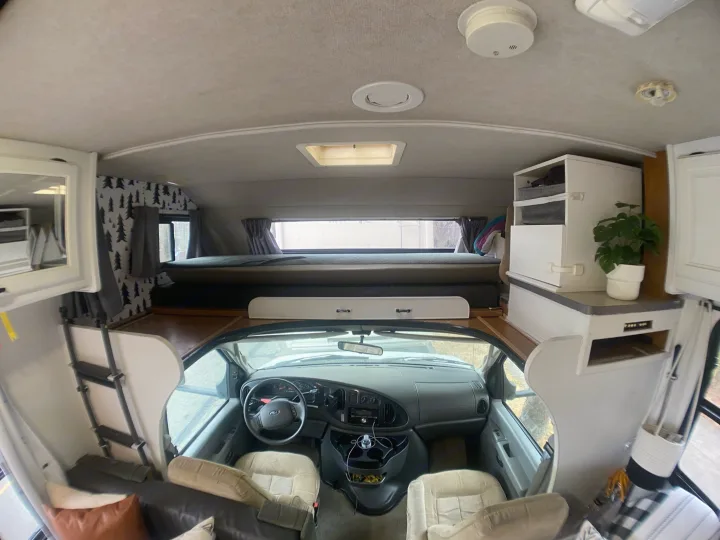 RV rental: Spacious camper interior featuring a bunk bed, cockpit, and storage, perfect for adventures.. Tioga Other 2006