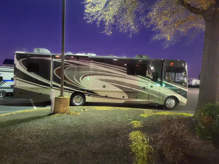 Large Challenger RV rental parked at night. This sleek motorhome is ready for your next travel adventure.. Thor Challenger 2015