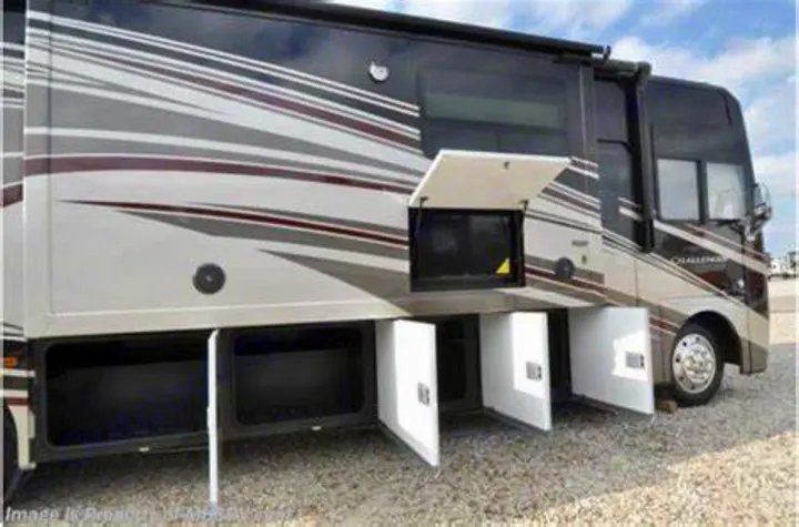 This spacious RV rental features multiple open exterior storage compartments and an outdoor TV, ideal for adventure.. Thor Challenger 2015