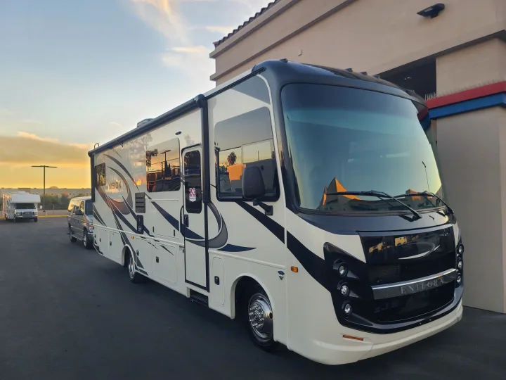 Modern Entegra Vision RV motorhome, white & black, bathed in sunset glow. Perfect for your next rv rental adventure.. Entegra Vision 29F 2022