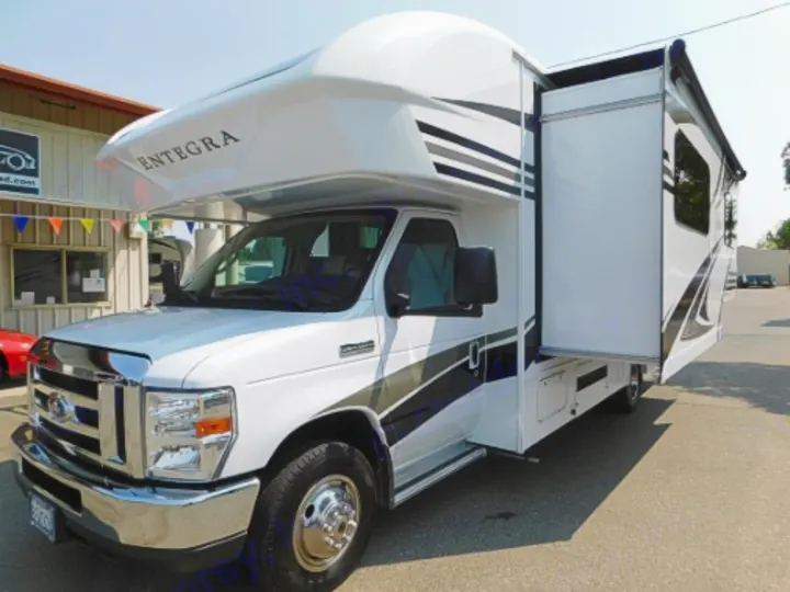 Spacious white and black Entegra Class C RV with an extended slide-out on a sunny day, ideal for rv rental.. Entegra Coach Odyssey 2019