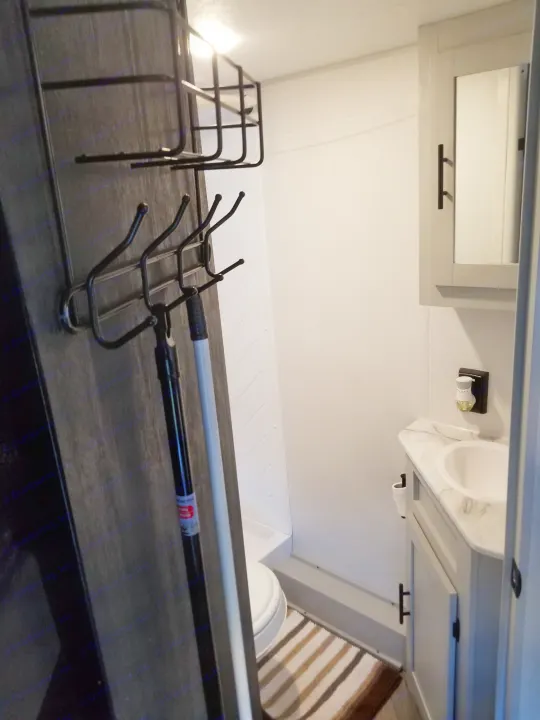 Marble bathroom sink with plug-in air freshener, eight hook accessibility, mop and broom included.. Forest River Salem FSX 2021