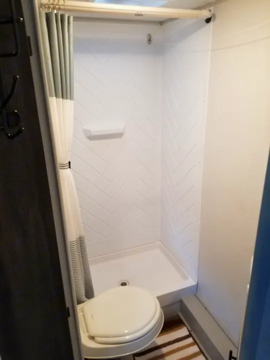 Large scale shower with herringbone tile walls and slip resistant flooring, deluxe shower curtains. . Forest River Salem FSX 2021