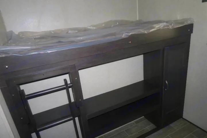 New RV rental bunk beds feature a mattress in plastic, built-in shelves, cabinet, and ladder access.. Palomino Puma 2018