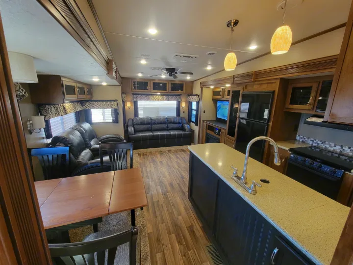 Spacious RV rental interior with living area, dining, and full kitchen, ideal for travel comfort.. Forest River Chaparral 2017