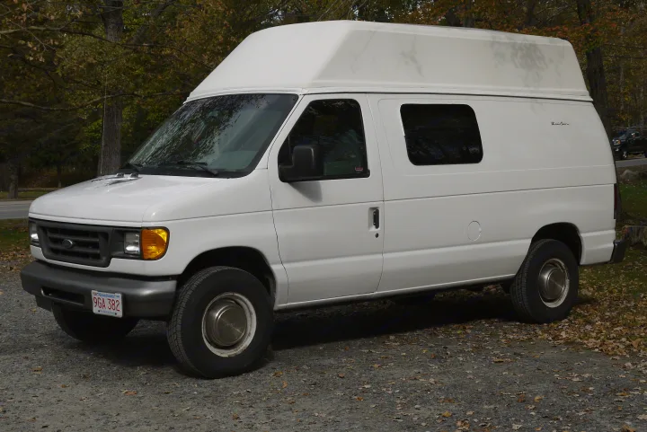 White Ford Econoline high-top camper van, a perfect RV rental for your next road trip.. Ford E350 Box Van 2003