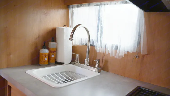 Clean & convenient kitchenette in an RV rental with Mrs. Meyer's soaps, a sink, and paper towels for easy travels.. Old School 818 2021