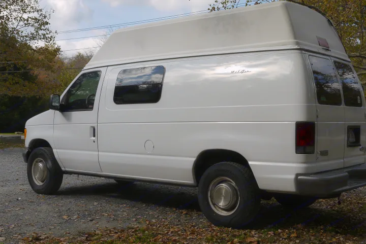 White high-top van with 'Bel-Air' script, perfect for your next rv rental adventure.. Ford E350 Box Van 2003