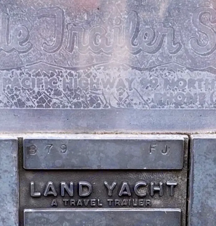 Embossed metallic sign for a "LAND YACHT A TRAVEL TRAILER" (379 FJ) on Pacific Highway 99. Explore vintage rv rental options.. Airstream Overlander 1969