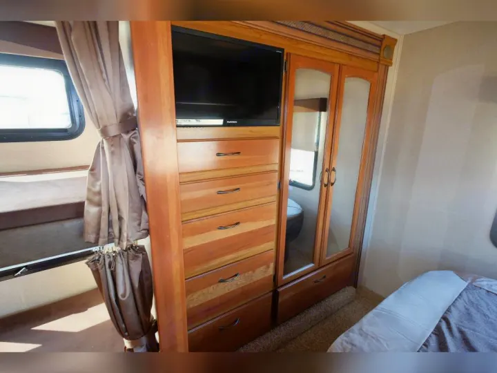 RV rental interior features bunk beds, an integrated TV, wardrobe, and ample storage for comfortable living.. Jayco Greyhawk 2016