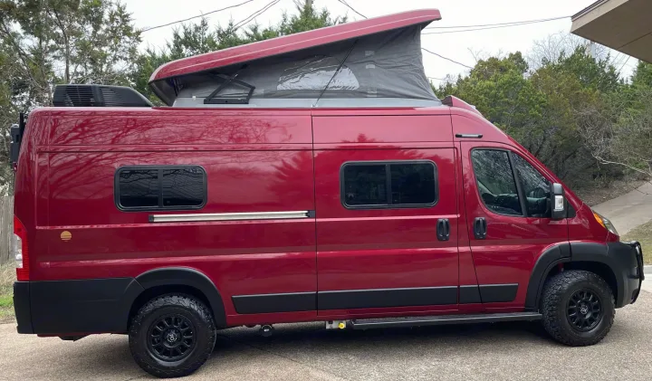 This eye-catching red pop-top camper van, equipped for adventure, is perfect for an RV rental experience.. Winnebago Solis 2021