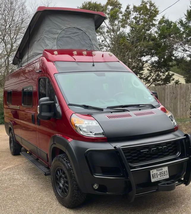 This red, rugged pop-top camper van, ideal for an RV rental, is ready for adventure with its custom modifications.. Winnebago Solis 2021
