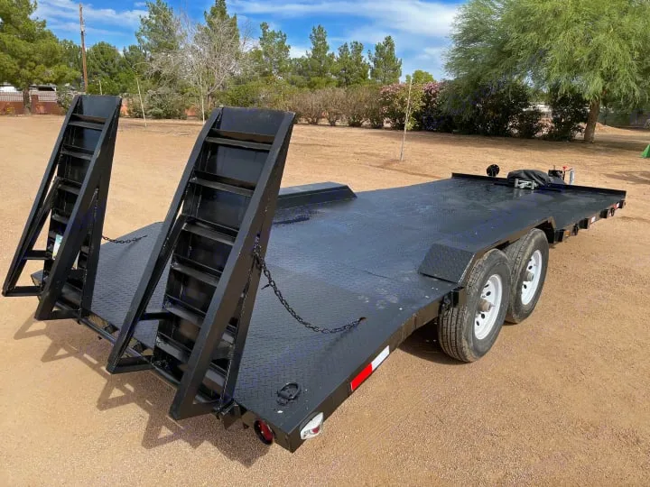 Black flatbed utility trailer with dual axles and large upright ramps. Ready for equipment transport or vehicle hauling, complementing an RV rental.. Big Tex 20" Flatbed 2014