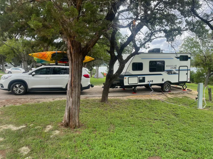Cubbie and my Subaru Ascent in a campsite.  Cubbie's smaller size makes it easy to pull with a large SUV and back into a camp site. Dutchmen Kodiak Cub 2018